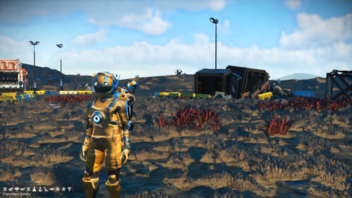 Screenshot from No Man's Sky game, game character standing near waste proceeesing plant, visible terrain with some far hills